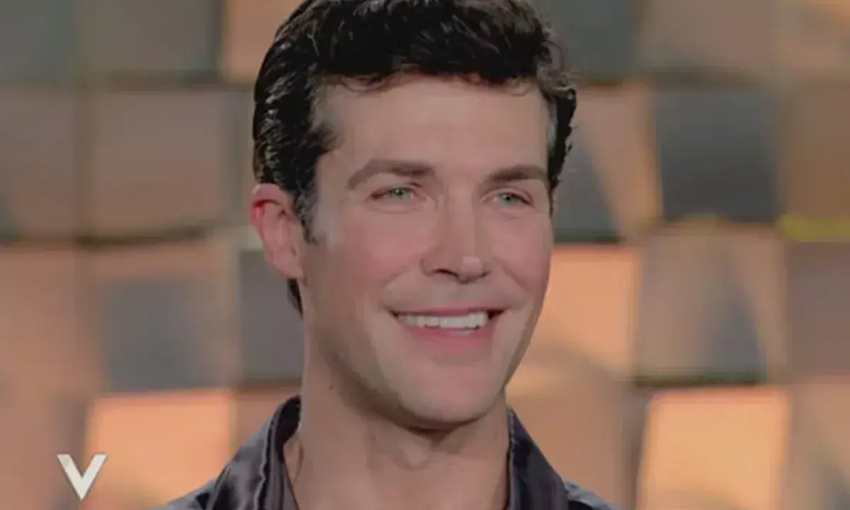 Roberto Bolle smiles, looking to the side.