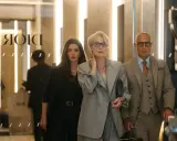 Anne Hathaway, Meryl Streep e Stanley Tucci camminano in un ambiente elegante, forse una boutique di lusso a Milano, ricordando "Il diavolo veste Prada 2".