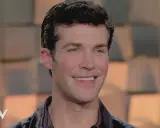 Roberto Bolle smiles, looking to the side.