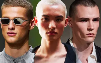 Tre volti con capelli cortissimi, un uomo con occhiali decorati, un altro con un taglio buzz cut donna, e un terzo con sguardo intenso.