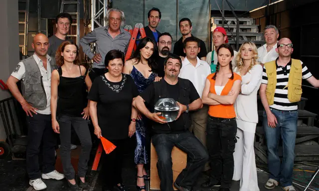 Il cast di Boris posa per una foto di gruppo, con un uomo che tiene una boccia con un pesce rosso.